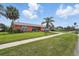 Charming home featuring a lush green lawn and a sidewalk at 100 Lynnhurst Dr, Ormond Beach, FL 32176