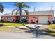 This single-story home features a well-maintained lawn and tropical landscaping at 100 Lynnhurst Dr, Ormond Beach, FL 32176