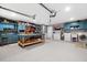 Organized garage featuring blue cabinetry, workbench, epoxy flooring, and laundry area with washer and dryer at 100 Lynnhurst Dr, Ormond Beach, FL 32176