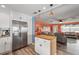 Open-concept kitchen featuring stainless steel appliances, open to the light filled living room at 100 Lynnhurst Dr, Ormond Beach, FL 32176