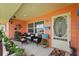 Inviting front porch with comfortable seating, decorative accents, and colorful details at 100 Lynnhurst Dr, Ormond Beach, FL 32176