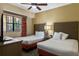 Comfortable bedroom featuring two beds, a TV, and an exterior view at 12544 Floridays Resort Dr # 507-B, Orlando, FL 32821