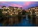 Beautiful sunset view of the resort buildings, pool and fountain at 12544 Floridays Resort Dr # 507-B, Orlando, FL 32821
