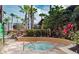 Serene hot tub area with lush landscaping and nearby lounge chairs at 12544 Floridays Resort Dr # 507-B, Orlando, FL 32821