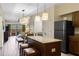 Modern kitchen area featuring granite countertops, stainless steel appliances, and bar seating at 12544 Floridays Resort Dr # 507-B, Orlando, FL 32821