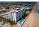 Aerial view of beachfront condos, pool, and beach access at 1575 Ocean Shore Blvd # 205, Ormond Beach, FL 32176