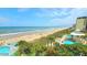 Beautiful aerial view of the beach with bright blue skies and ocean water at 1575 Ocean Shore Blvd # 205, Ormond Beach, FL 32176