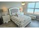 Serene bedroom features ocean view, sea-themed decor, and two bedside tables with lamps at 1575 Ocean Shore Blvd # 205, Ormond Beach, FL 32176