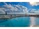 Outdoor pool area with clear blue water, lounge chairs, and an ocean view at 1575 Ocean Shore Blvd # 205, Ormond Beach, FL 32176