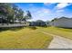 This backyard features a large lawn, white fence, and screened pool at 1705 Cordova Ave, Daytona Beach, FL 32117