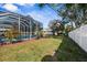 Spacious fenced backyard with lush greenery and sparkling pool at 1705 Cordova Ave, Daytona Beach, FL 32117