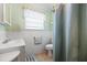 Bright bathroom with a shower/tub, tiled walls, and a window for natural light at 1705 Cordova Ave, Daytona Beach, FL 32117