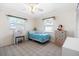 Charming bedroom with decorative dresser, floral accents, and ample natural light from large windows at 1705 Cordova Ave, Daytona Beach, FL 32117