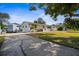 Well-maintained home with a long driveway, large tree and tidy landscaping at 1705 Cordova Ave, Daytona Beach, FL 32117