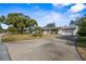 View of a single-story house with an attached garage, front yard, and long concrete driveway at 1705 Cordova Ave, Daytona Beach, FL 32117