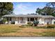 A delightful home with a cozy front porch, neat landscaping, and an attached garage at 1705 Cordova Ave, Daytona Beach, FL 32117