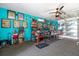 Eclectic game room with bright blue walls, pinball machines, and unique wall art at 1705 Cordova Ave, Daytona Beach, FL 32117