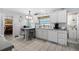 Bright kitchen features white cabinetry, tiled floors, and a peninsula with seating, perfect for casual dining at 1705 Cordova Ave, Daytona Beach, FL 32117