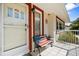 Charming porch area with a patriotic bench, perfect for relaxing outdoors at 1705 Cordova Ave, Daytona Beach, FL 32117