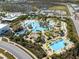 Aerial view of community pool with tropical landscaping, lounge chairs, and surrounding residential area at 243 Island Breeze Ave, Daytona Beach, FL 32124