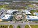 Aerial view of community buildings with roundabout, landscaping, and commercial establishments at 243 Island Breeze Ave, Daytona Beach, FL 32124