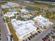 Aerial view of community buildings, parking, playground, and pool with surrounding residential area at 243 Island Breeze Ave, Daytona Beach, FL 32124