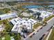 Aerial view of community buildings with parking, landscaping, and nearby lake and residential area at 243 Island Breeze Ave, Daytona Beach, FL 32124