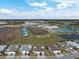 This aerial shows an overview of the community with tennis courts and a lake at 243 Island Breeze Ave, Daytona Beach, FL 32124