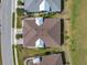 An aerial view of a home featuring a well-maintained roof and surrounding green lawn at 243 Island Breeze Ave, Daytona Beach, FL 32124