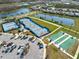 Aerial view of the community recreational area including tennis, pickleball, bocce ball courts and parking at 243 Island Breeze Ave, Daytona Beach, FL 32124