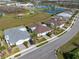 An aerial view of single-Gathering homes with nearby tennis courts and green spaces at 243 Island Breeze Ave, Daytona Beach, FL 32124