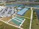 Aerial view of the community recreational area with tennis, pickleball, bocce ball courts and parking at 243 Island Breeze Ave, Daytona Beach, FL 32124