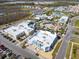 Aerial view of neighborhood commercial buildings with surrounding parking and residential area at 243 Island Breeze Ave, Daytona Beach, FL 32124