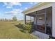 A view from the backyard featuring the screened in lanai with outdoor seating and backyard at 243 Island Breeze Ave, Daytona Beach, FL 32124