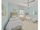 Bright bedroom featuring twin beds, wicker headboards, and a coastal-themed decor at 243 Island Breeze Ave, Daytona Beach, FL 32124