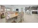 Bright dining area features stylishly upholstered chairs and a wooden table, adjacent to the living room at 243 Island Breeze Ave, Daytona Beach, FL 32124