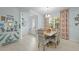 Dining area with a modern chandelier, colorful decor, tropical patterned curtains, and stylish furnishings at 243 Island Breeze Ave, Daytona Beach, FL 32124