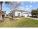 Lovely one-story home with a manicured lawn, mature landscaping, and a two-car garage at 243 Island Breeze Ave, Daytona Beach, FL 32124