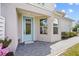 Charming front entrance with a blue door, brick walkway, and well-maintained landscaping at 243 Island Breeze Ave, Daytona Beach, FL 32124