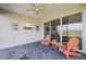 Outdoor living space with a ceiling fan and stone flooring, perfect for enjoying warm Florida weather at 243 Island Breeze Ave, Daytona Beach, FL 32124