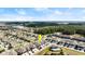 Aerial view of community featuring townhomes, lush greenery, a lake, and a community pool at 3411 Gallia St, New Smyrna Beach, FL 32168