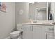 Clean, well-lit bathroom features a modern vanity, neutral decor, and a neatly arranged toilet at 3411 Gallia St, New Smyrna Beach, FL 32168