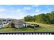 Community pool area surrounded by lush landscaping, viewed from a balcony at 3411 Gallia St, New Smyrna Beach, FL 32168