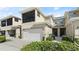 Exterior of home featuring an attached garage, second story balcony, and well-maintained landscaping at 3411 Gallia St, New Smyrna Beach, FL 32168