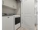 Efficient laundry area with a full-size washer and dryer, plus overhead cabinets for storage at 3411 Gallia St, New Smyrna Beach, FL 32168