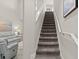 Carpeted staircase leading to the upper level of the home at 3411 Gallia St, New Smyrna Beach, FL 32168