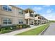 Street view of a row of townhomes with manicured lawns and common sidewalk at 3411 Gallia St, New Smyrna Beach, FL 32168