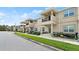 Street view of townhomes with covered porches and landscaped front yards at 3411 Gallia St, New Smyrna Beach, FL 32168