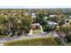 Aerial view of a single Gathering home with driveway, surrounded by mature trees at 630 W Rich Ave, Deland, FL 32720