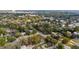 Neighborhood view of a home site surrounded by verdant trees, with commercial buildings along the highway at 630 W Rich Ave, Deland, FL 32720